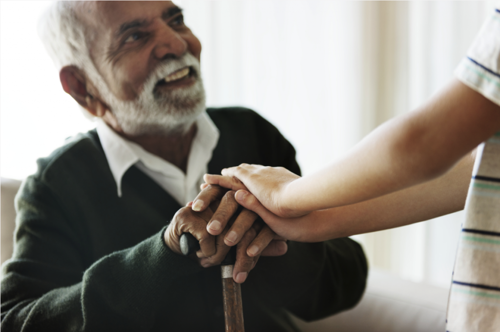 Older man receiving support from child at home