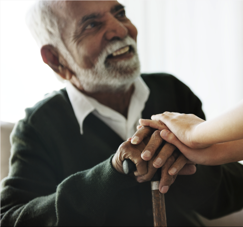 Older man receiving support from child at home
