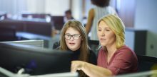 Young girl learning cyber safety from Support Worker