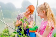 Girl and her Support Worker helping out at a garden