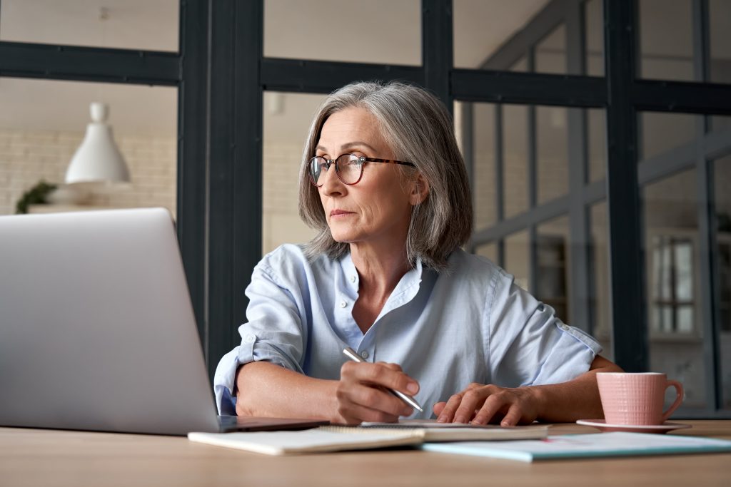 woman using computer technology sitting at table