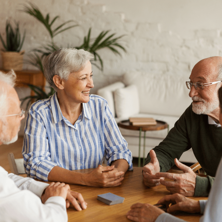 Group of older people having conversation at table