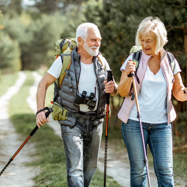 two active senior people hiking outdoors