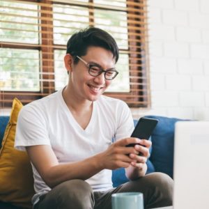 A young man using his phone.