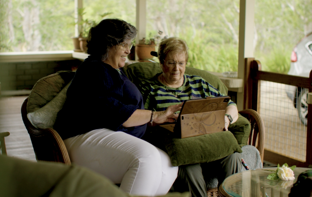 Carol and her daughter Pieta using an ipad