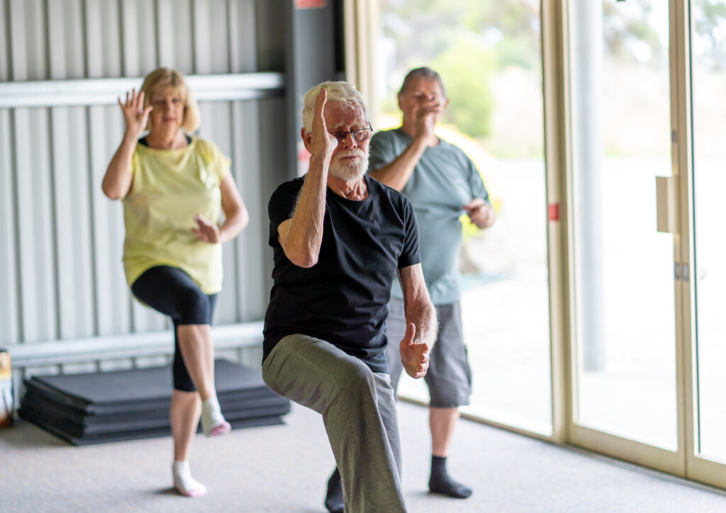 Group of older Australians take part in a Tai chi class together.