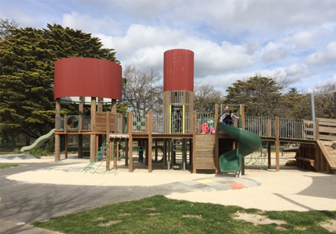Livvi's Place playground in Ballarat in sand with large cylindrical structures.