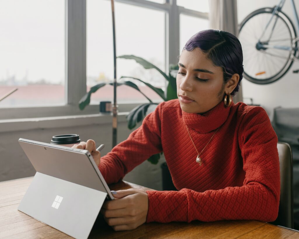 A woman working on a laptop.