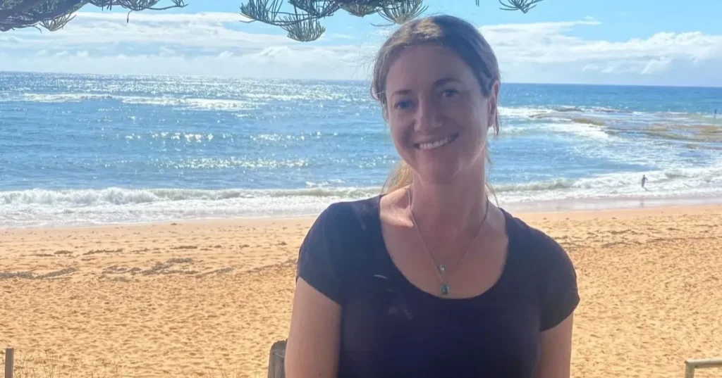 Lana Hallowes stands at the beach