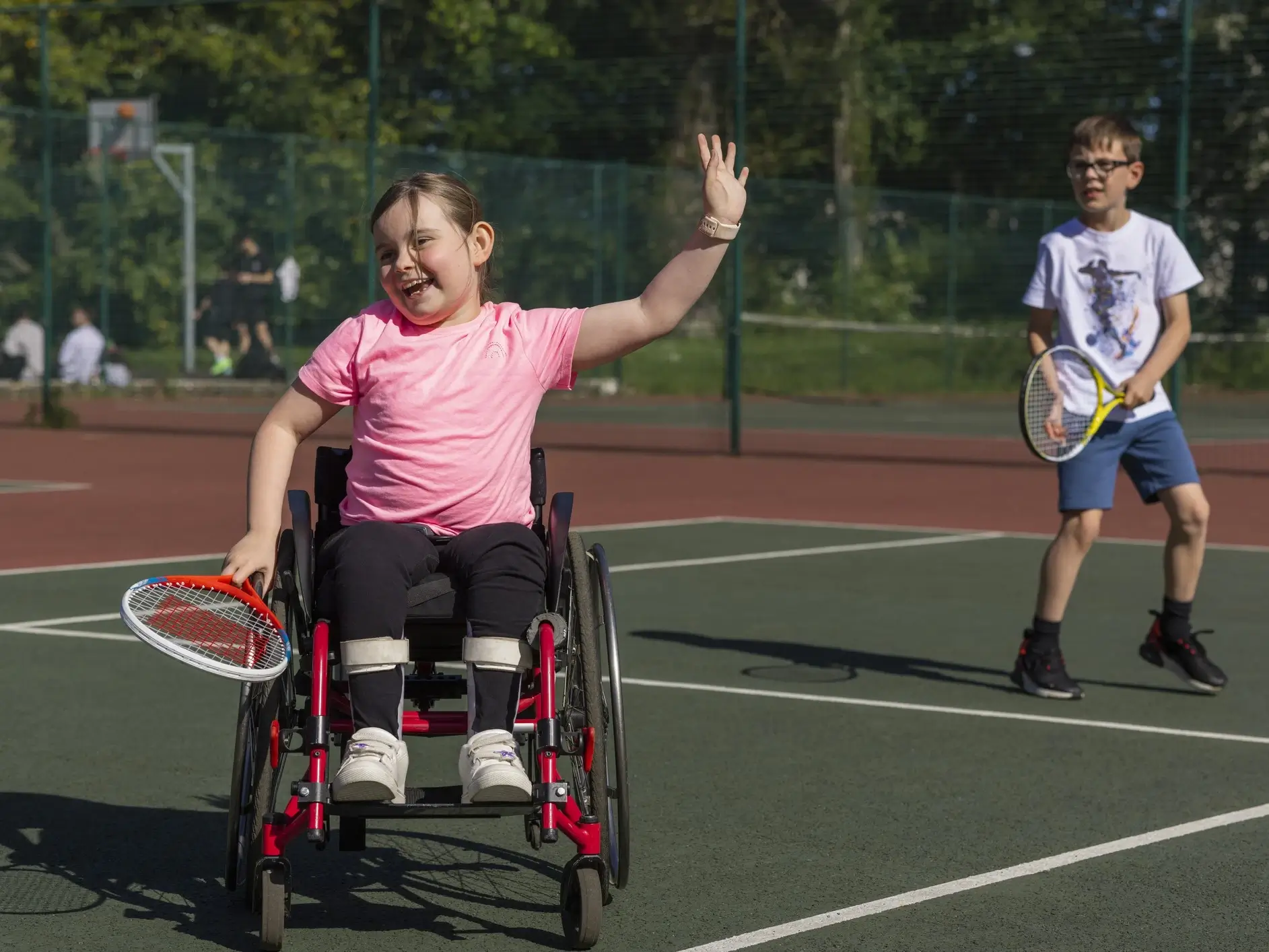 Child with mobility aids playing tennis