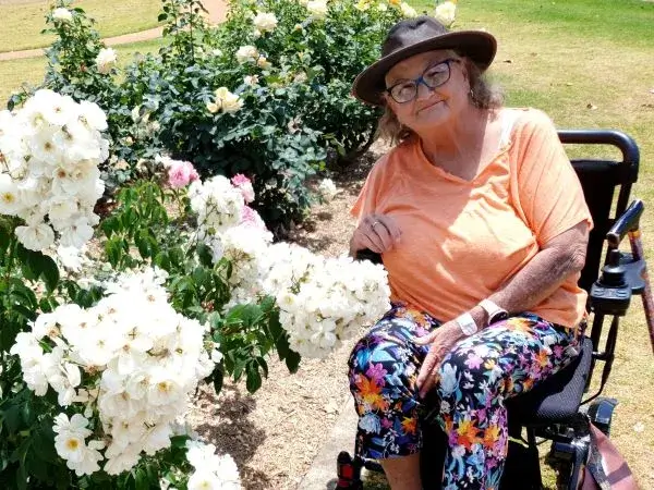Mable client Pam smiling in her garden