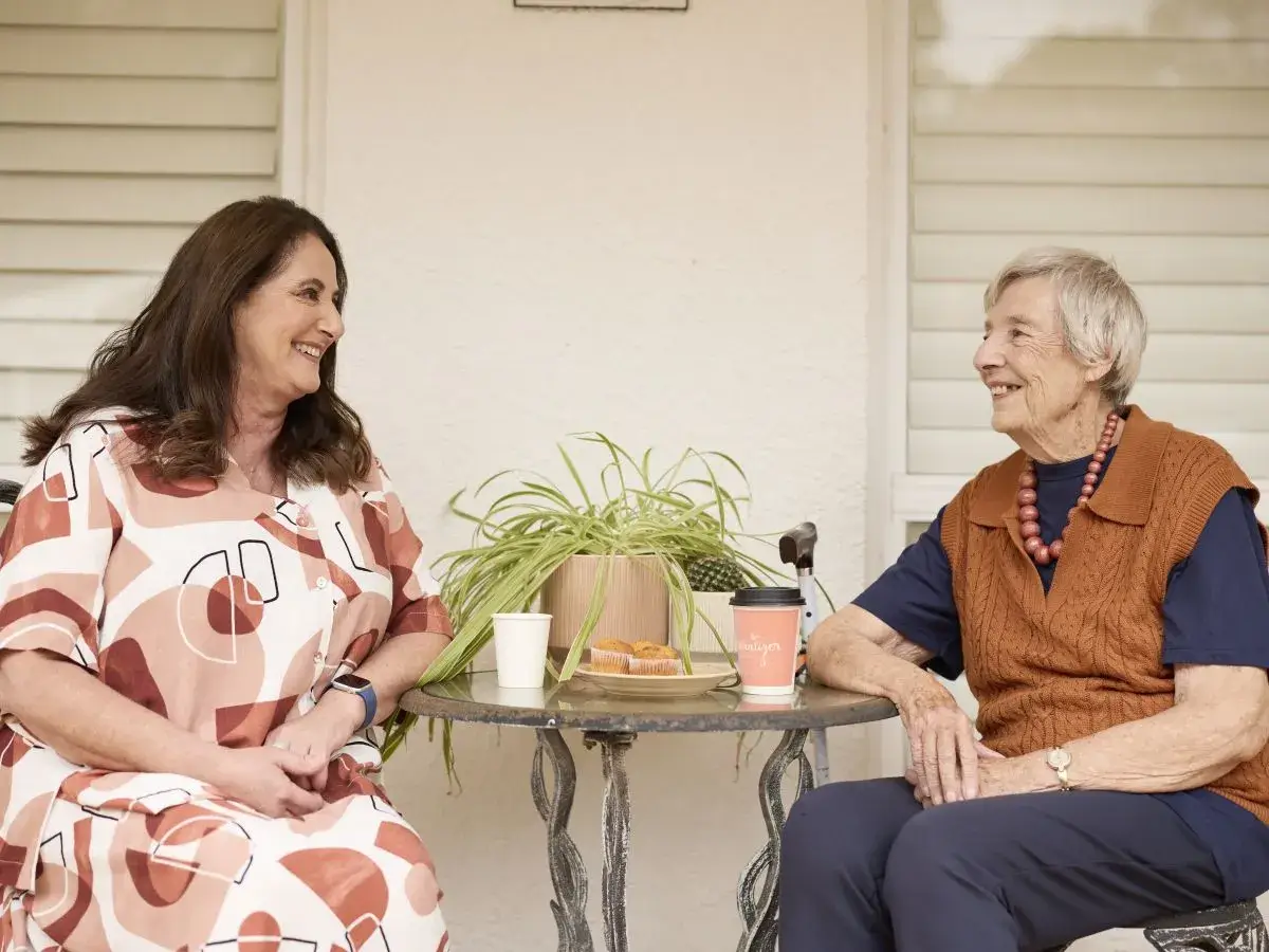 Mable client Elizabeth sits and has a coffee with her independent support worker Doreen.