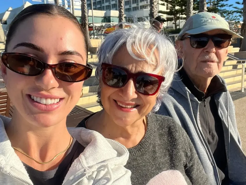 Support worker Nicola smiles with her client and his wife Nicola