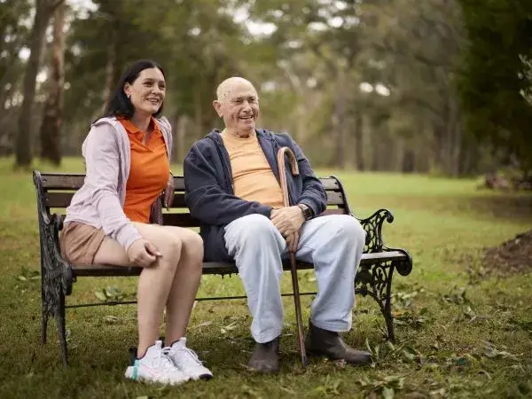Independent support worker Renee sits with her Mable client Con on a park bench