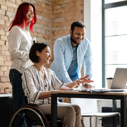Group of three colleagues working together in office environment