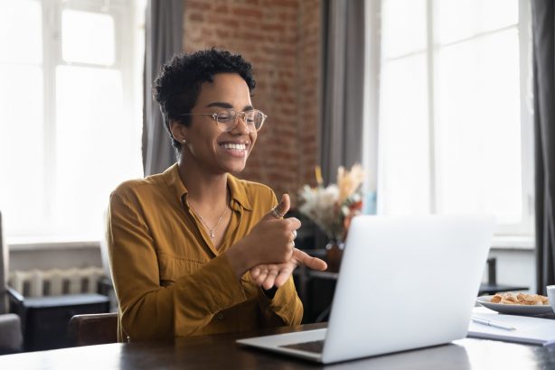 A woman on a video call using sign language.