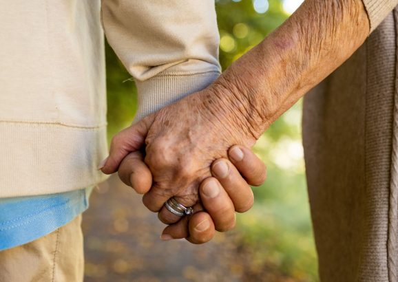 Older couple holding hands