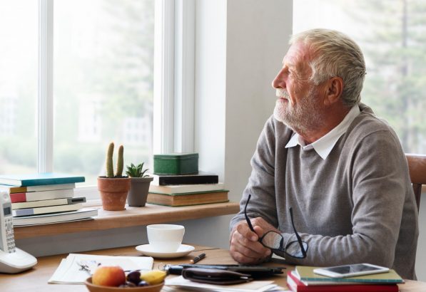 An older man working at his desk.