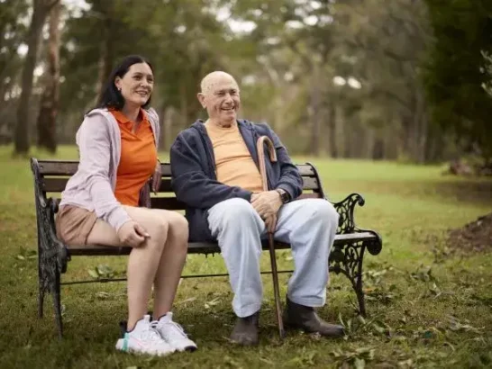 Independent support worker Renee sits with her Mable client Con on a park bench