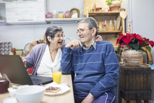 Cheerful senior couple having breakfast