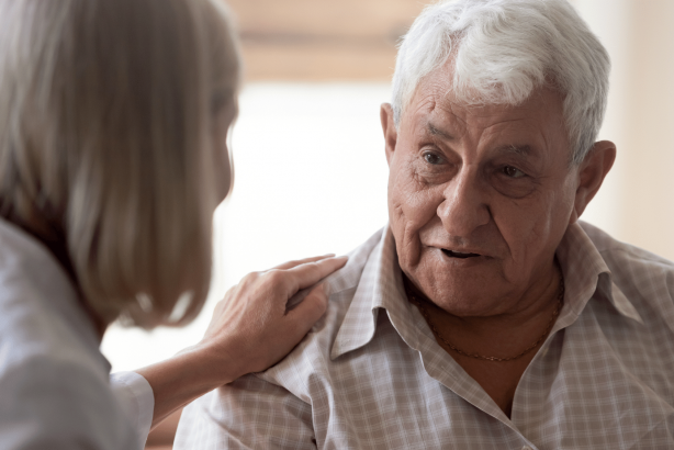 A support worker and her aged care client talking together.