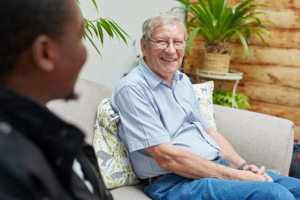 elderly man speaking with support worker