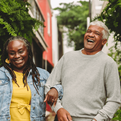 two senior people appearing cheerful together in outdoor environment
