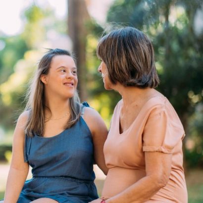 Two women chatting outdoors together.