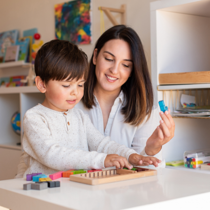 A mother and her young son play with blocks together.